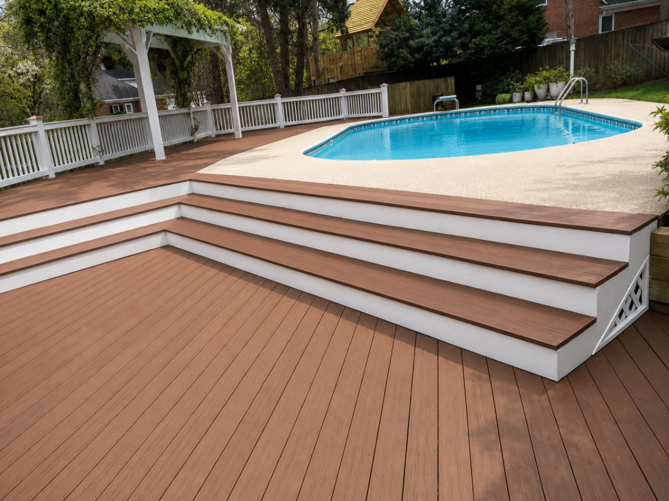 Poolside composite deck with pergola and clean stair detailing